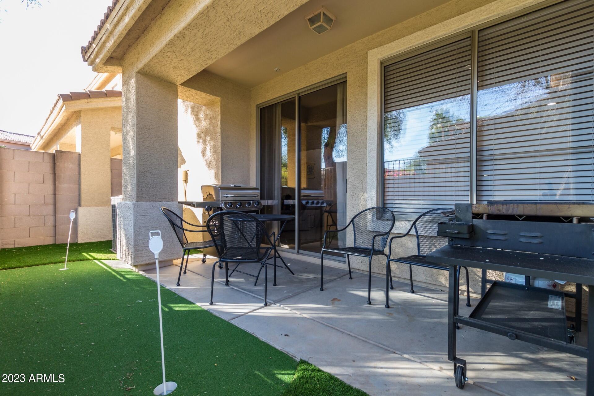 5415 East McKellips Road, Unit 94 Mesa, AZ 85215 - Photo 23 of 64 a view of a patio with table and chairs and potted plants