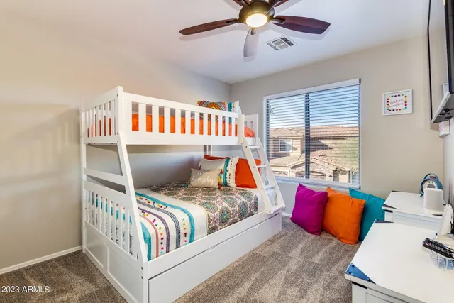 a bedroom with a bed and a chandelier