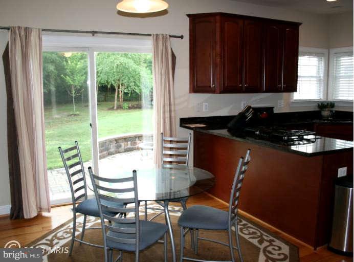 4027 Brummel Road Pasadena, MD 21122 - Photo 11 of 25 a kitchen with a table chairs and a window