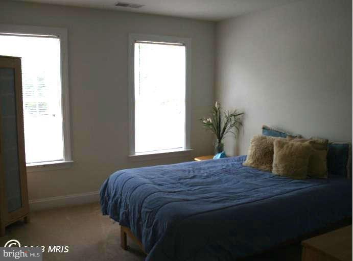 4027 Brummel Road Pasadena, MD 21122 - Photo 21 of 25 a bedroom with a bed and a window