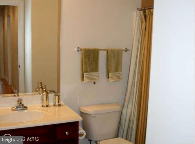 4027 Brummel Road Pasadena, MD 21122 - Photo 22 of 25 a bathroom with a sink and a mirror
