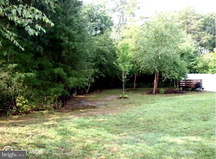 4027 Brummel Road Pasadena, MD 21122 - Photo 25 of 25 a view of outdoor space with deck and yard