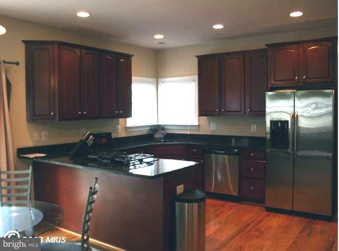 4027 Brummel Road Pasadena, MD 21122 - Photo 10 of 25 a kitchen with granite countertop stainless steel appliances a stove a sink and a microwave
