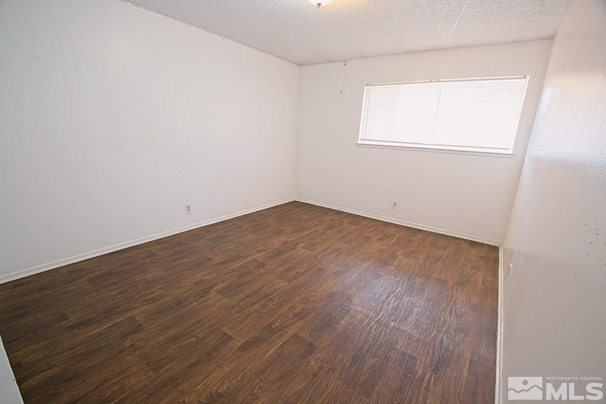 1131 Parkview Street Reno, NV 89502 - Photo 5 of 6 an empty room with wooden floor and windows