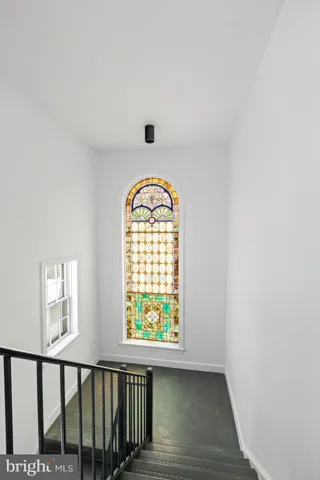 a view of roof deck with seating space and wooden floor