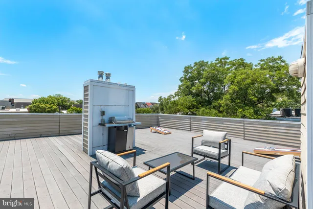 a terrace with outdoor seating and trees