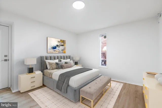 an empty room with wooden floor and white walls