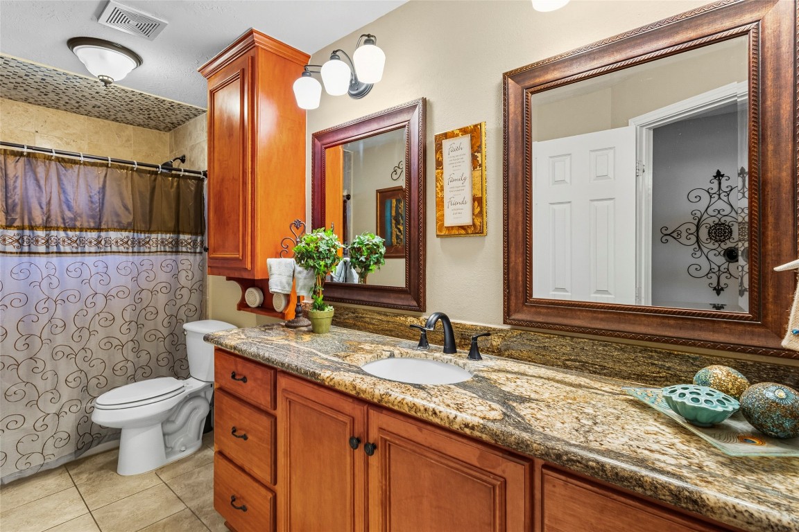 200 Trott Lane Point Blank, TX 77364 - Photo 20 of 50 a bathroom with a granite countertop sink and a mirror