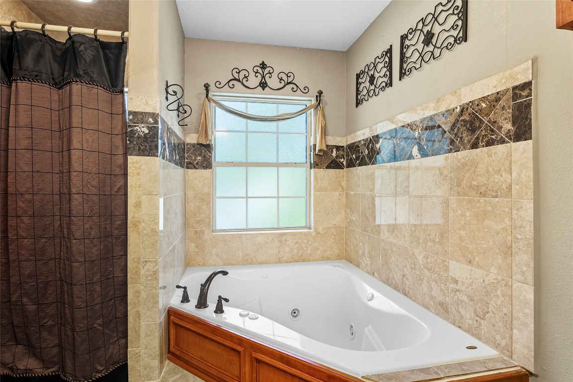 200 Trott Lane Point Blank, TX 77364 - Photo 31 of 50 a bathroom with a bathtub and shower