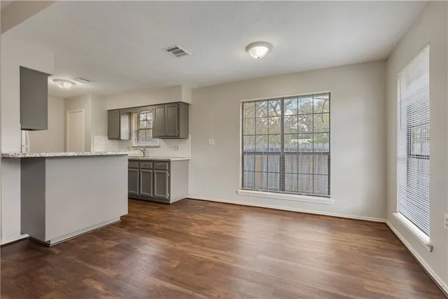 a view of a kitchen with granite countertop cabinets and a wooden floor