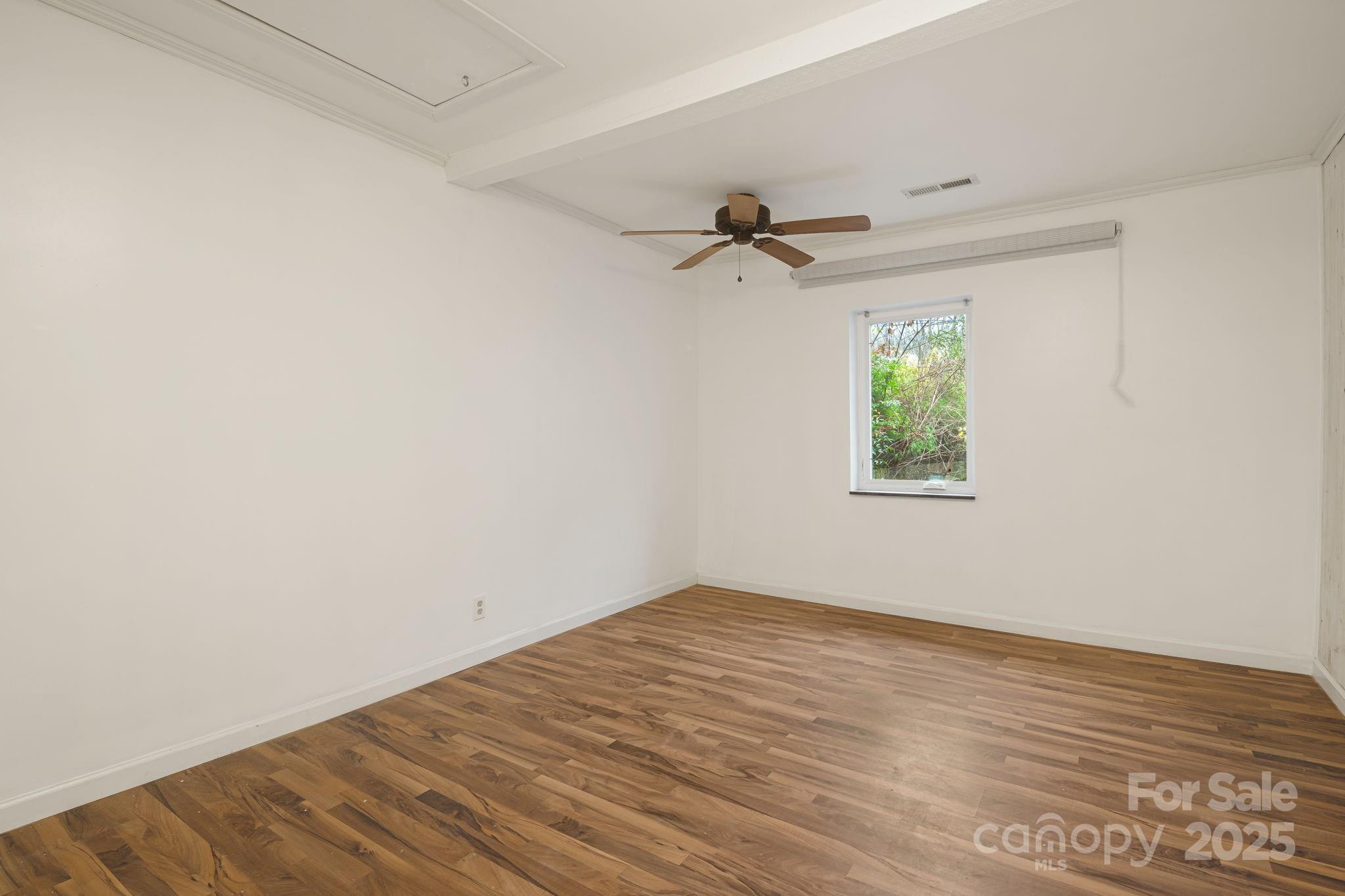 814 Little Creek Road Burnsville, NC 28714 - Photo 12 of 32 an empty room with a window and a ceiling fan
