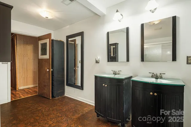 a bathroom with double sink and mirror