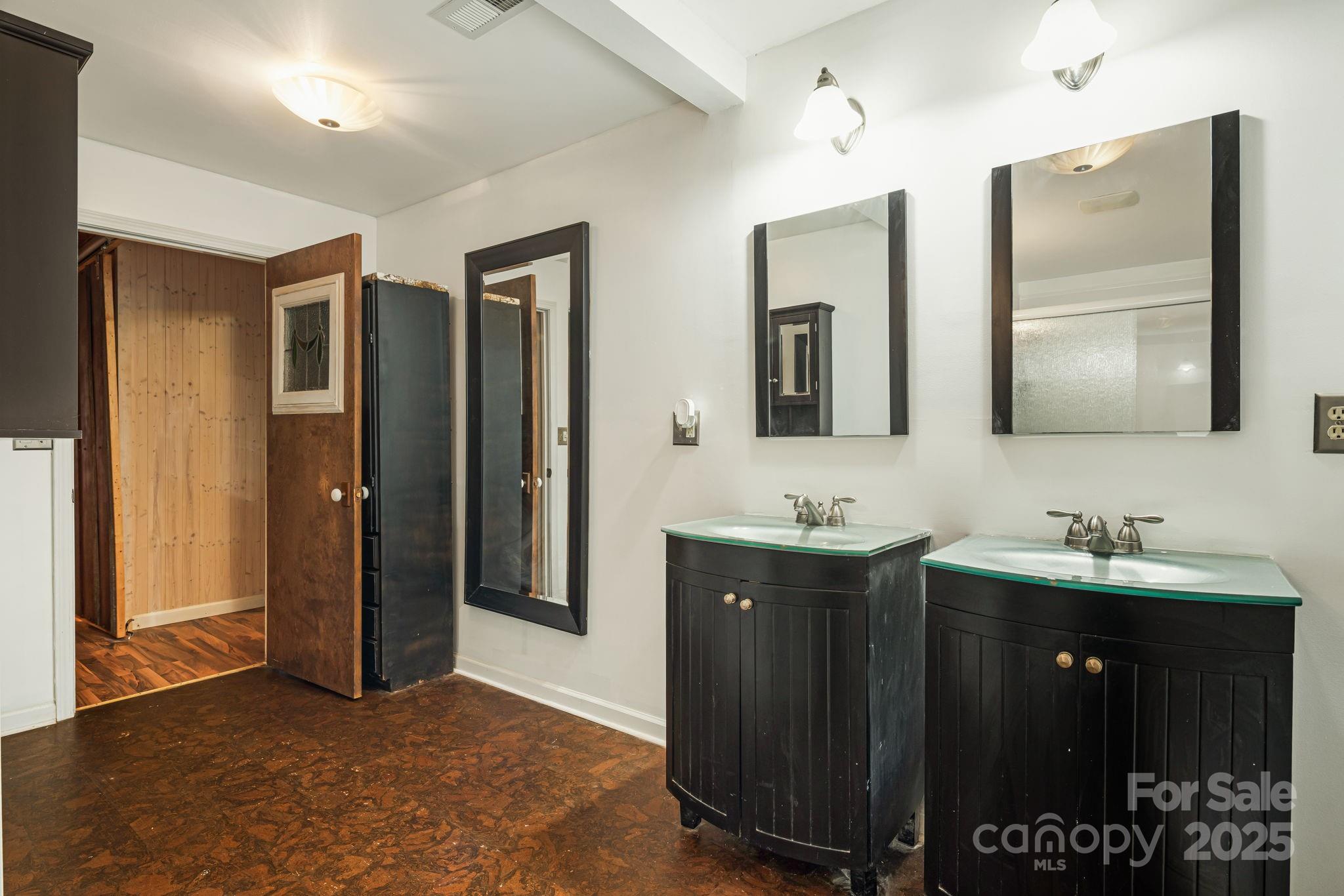 814 Little Creek Road Burnsville, NC 28714 - Photo 16 of 32 a bathroom with double sink and mirror