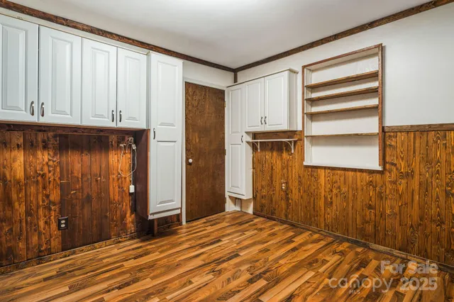 a view of a room with wooden floor and cabinet