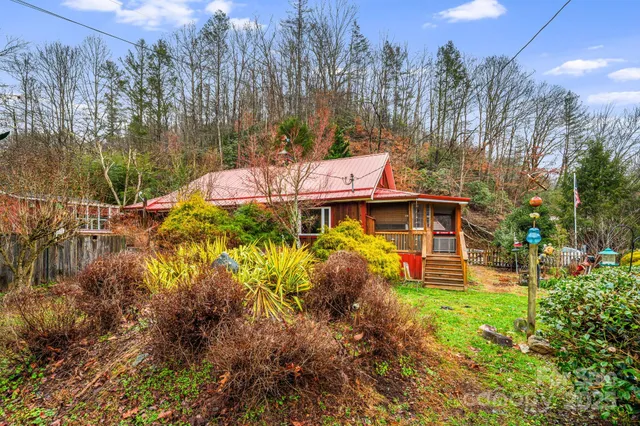 a view of a house with a yard and sitting area