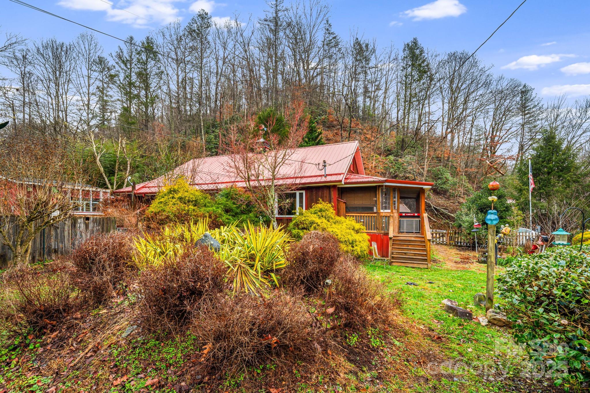 814 Little Creek Road Burnsville, NC 28714 - Photo 19 of 32 a view of a house with a yard and sitting area