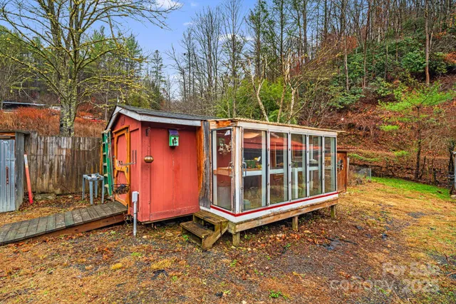 a view of a house with a yard and wooden fence