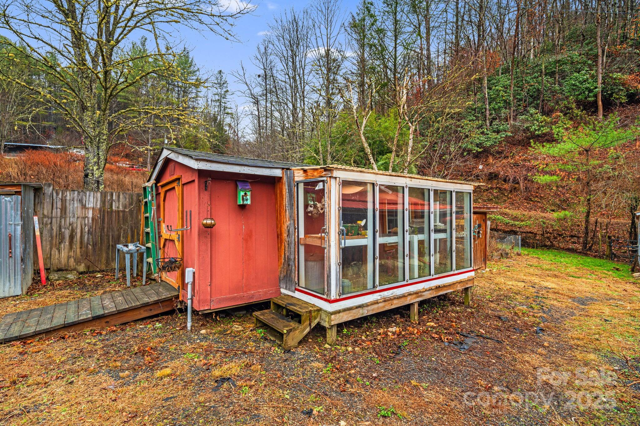 814 Little Creek Road Burnsville, NC 28714 - Photo 24 of 32 a view of a house with a yard and wooden fence