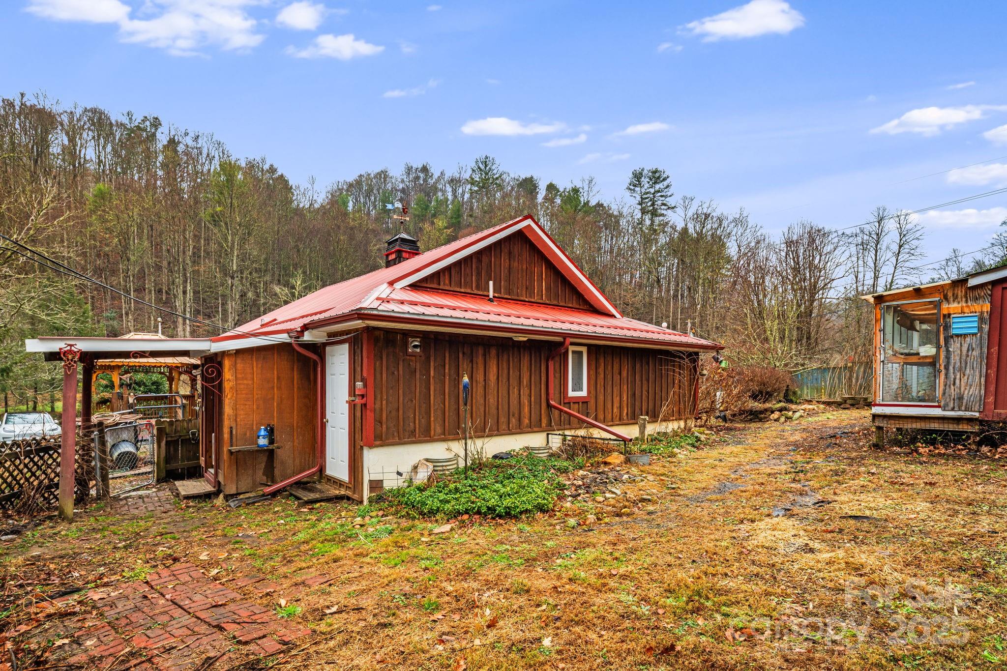814 Little Creek Road Burnsville, NC 28714 - Photo 26 of 32 a front view of a house with a yard