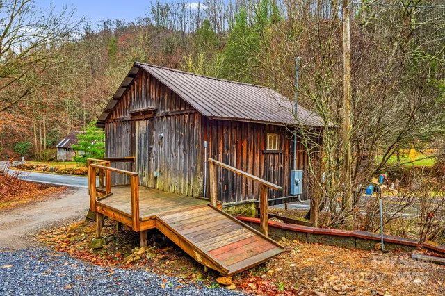 a view of backyard with a deck and a patio