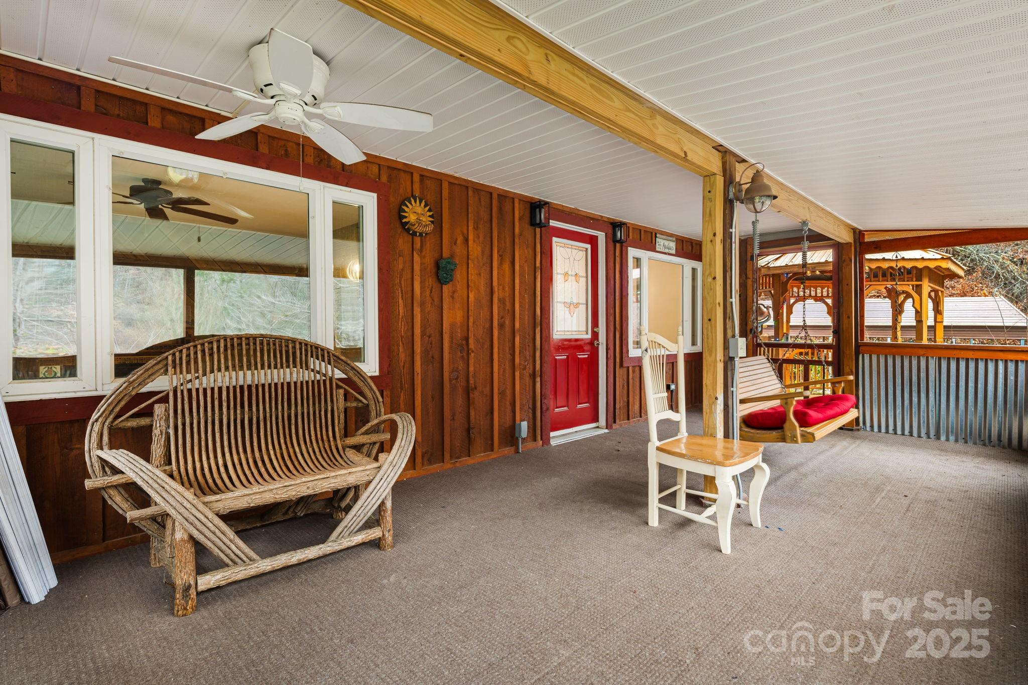 814 Little Creek Road Burnsville, NC 28714 - Photo 3 of 32 a bedroom with a bunk bed and a window