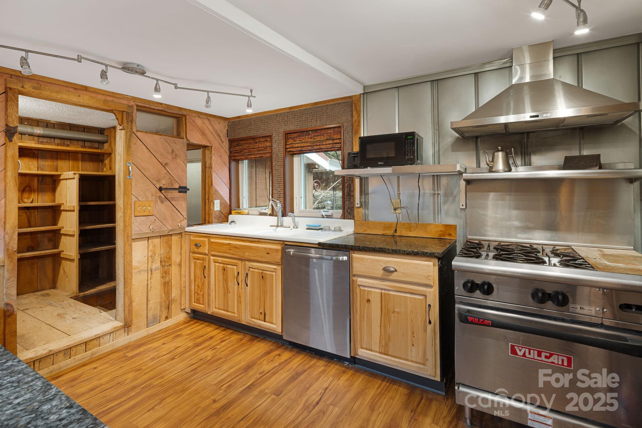 814 Little Creek Road Burnsville, NC 28714 - Photo 8 of 32 a kitchen with stainless steel appliances granite countertop a stove and a sink