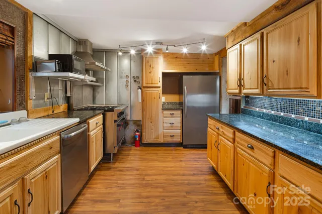 a kitchen with stainless steel appliances a refrigerator and a sink