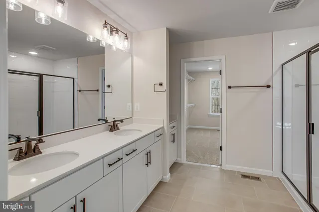 a bathroom with a double vanity sink mirror and double