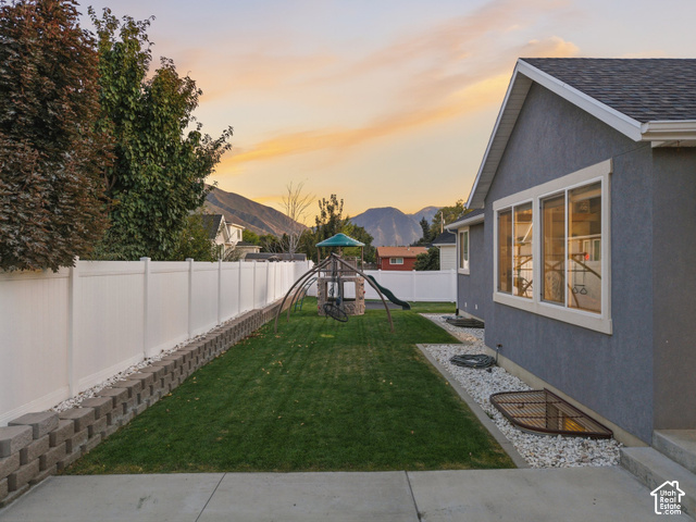474 North 150th Street East Mapleton, UT 84664 - Photo 26 of 35 Expansive backyard with a manicured lawn, white privacy fencing, and a concrete patio