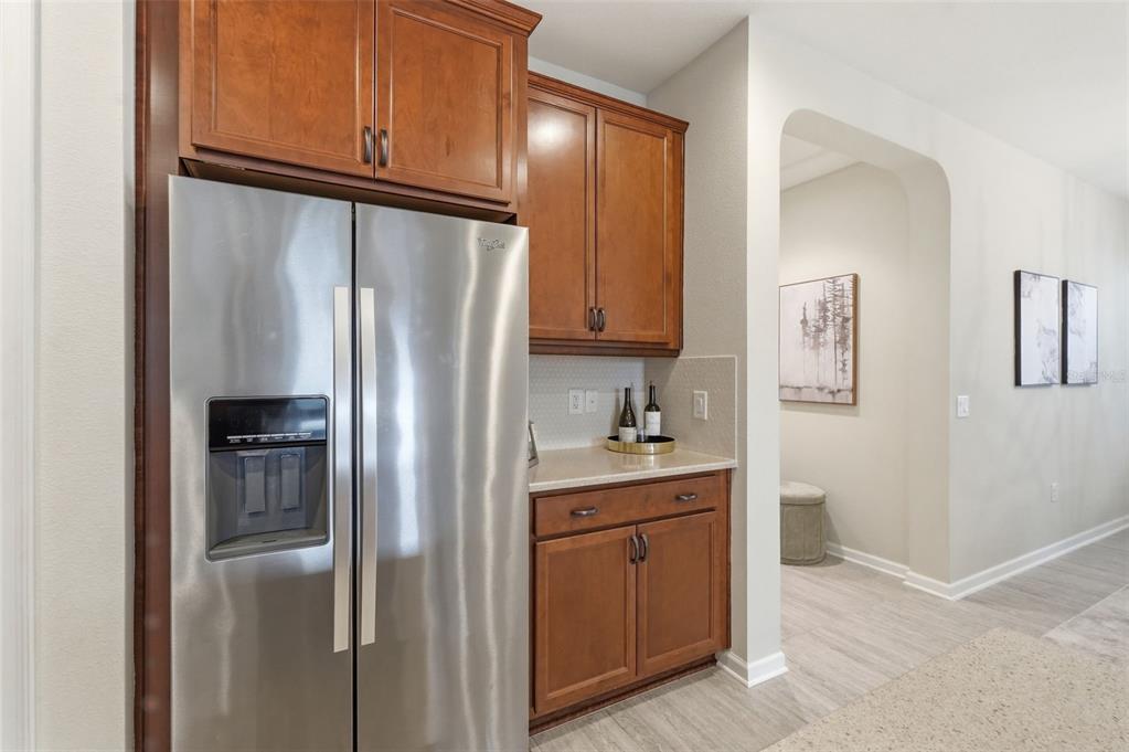 29241 Perilli Place Wesley Chapel, FL 33543 - Photo 14 of 53 a kitchen with stainless steel appliances granite countertop a refrigerator and a stove