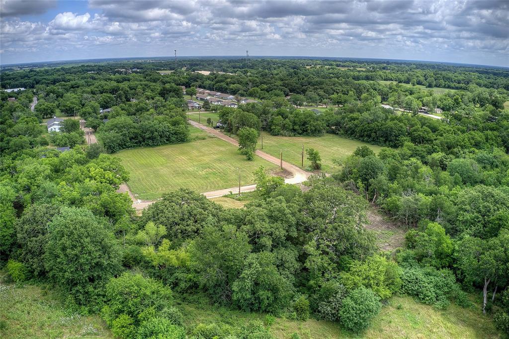 Tbd Sycamore Street Commerce, TX 75428 - Photo 4 of 11 a view of a big yard with a house in the background