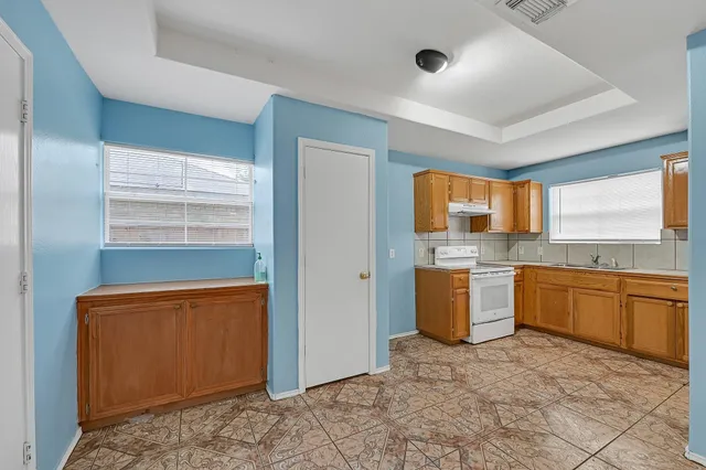 a kitchen with a stove a sink and a refrigerator