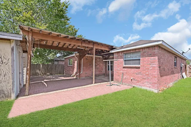 a backyard of a house with table and chairs