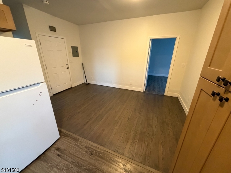 64 Mott Street, Unit 2 Newark, NJ 07105 - Photo 3 of 14 a view of an empty room with wooden floor and a window
