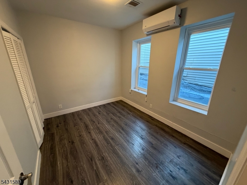 64 Mott Street, Unit 2 Newark, NJ 07105 - Photo 4 of 14 a view of a room with wooden floor and window