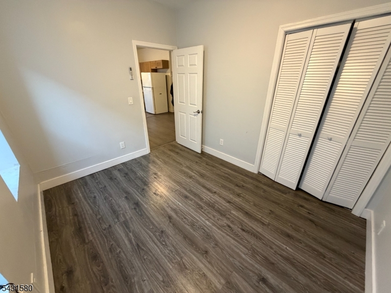 64 Mott Street, Unit 2 Newark, NJ 07105 - Photo 5 of 14 a view of empty room with wooden floor