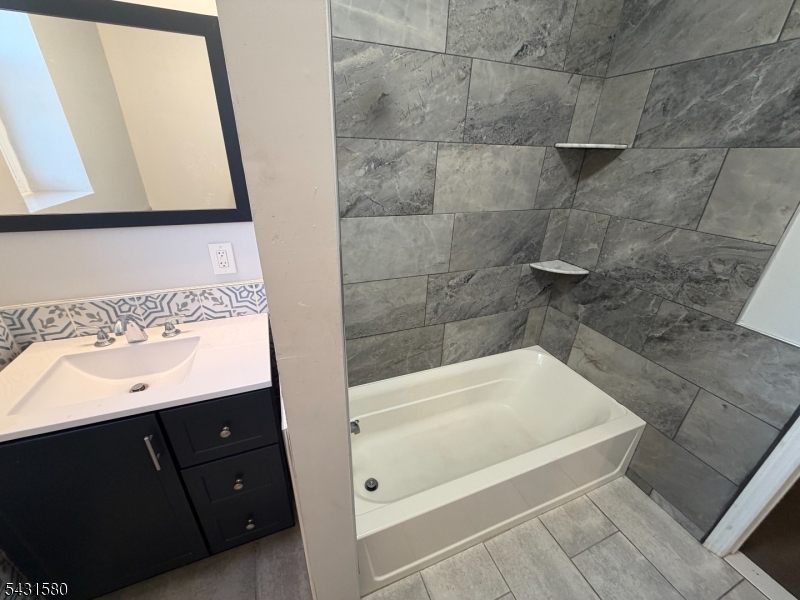 64 Mott Street, Unit 2 Newark, NJ 07105 - Photo 7 of 14 a bathroom with a bathtub and a sink