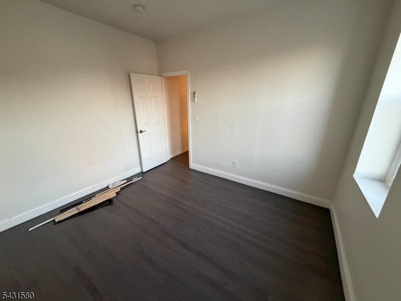 64 Mott Street, Unit 2 Newark, NJ 07105 - Photo 9 of 14 an empty room with wooden floor