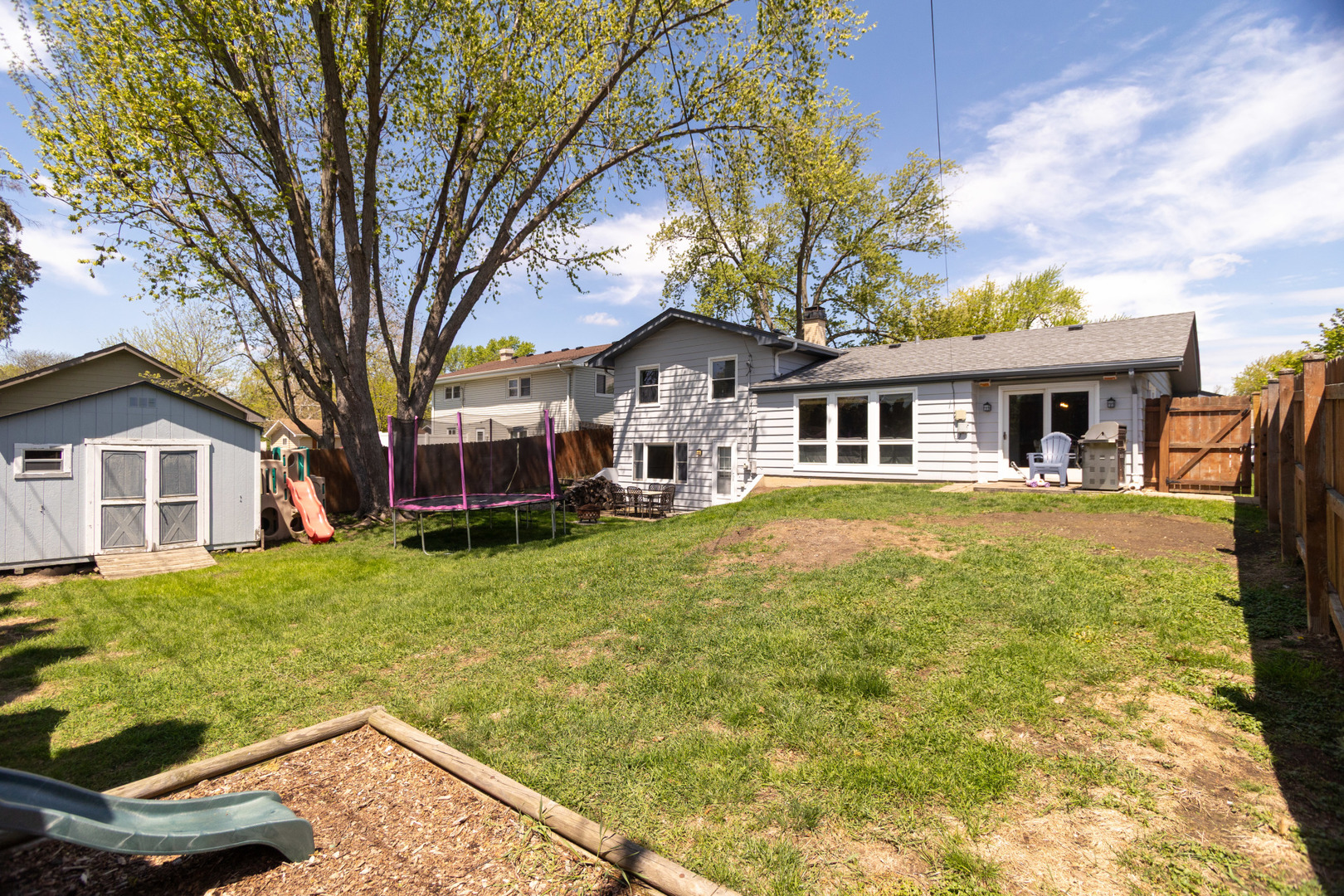 1485 Devonshire Lane Hoffman Estates, IL 60169 - Photo 22 of 27 a front view of a house with a yard