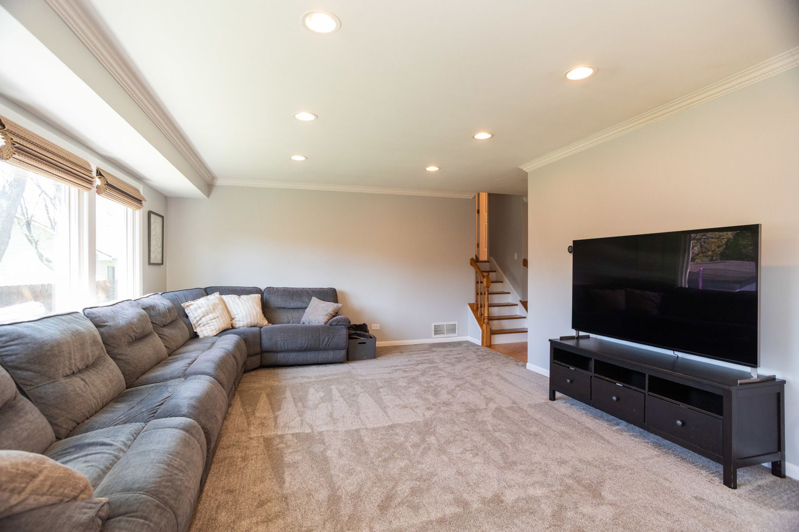 1485 Devonshire Lane Hoffman Estates, IL 60169 - Photo 4 of 27 a living room with furniture and a flat screen tv