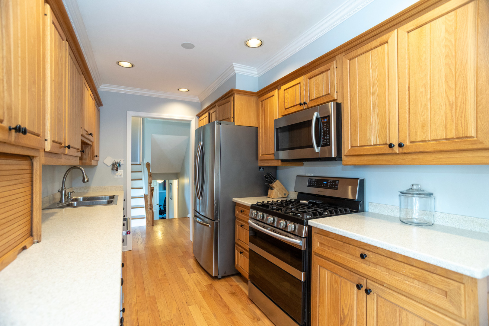 1485 Devonshire Lane Hoffman Estates, IL 60169 - Photo 8 of 27 a kitchen with stainless steel appliances a stove a sink a microwave and cabinets