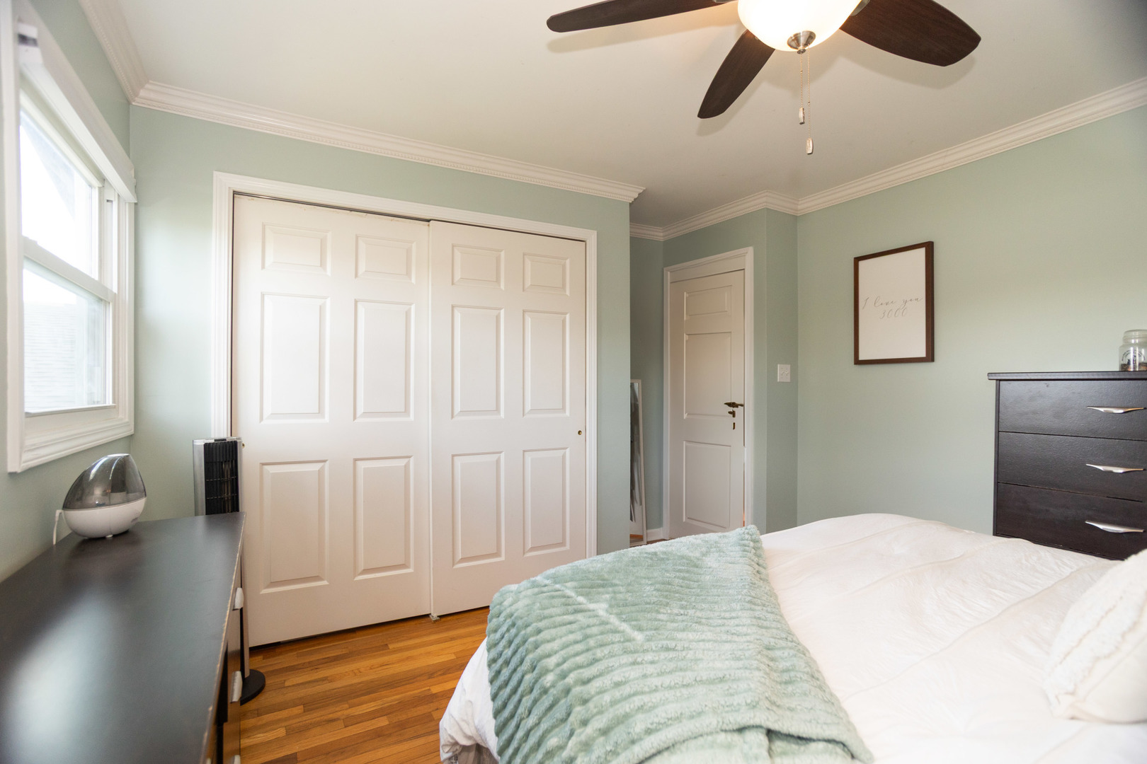 1485 Devonshire Lane Hoffman Estates, IL 60169 - Photo 10 of 27 a bedroom with a bed and a chandelier