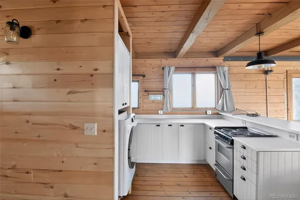a kitchen with a sink cabinets and wooden floor