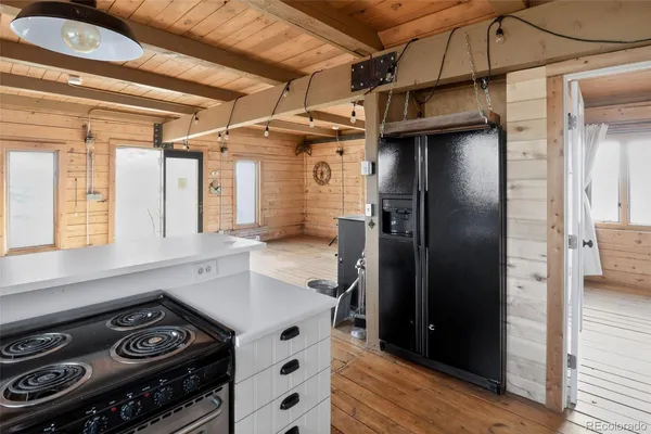 a kitchen with stainless steel appliances granite countertop a refrigerator and a stove
