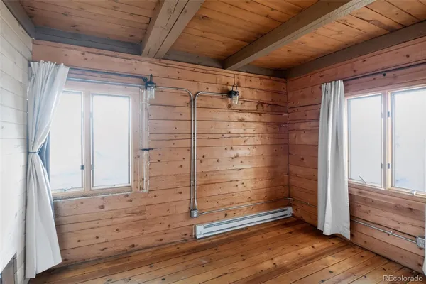 a view of walk in closet with wooden floor