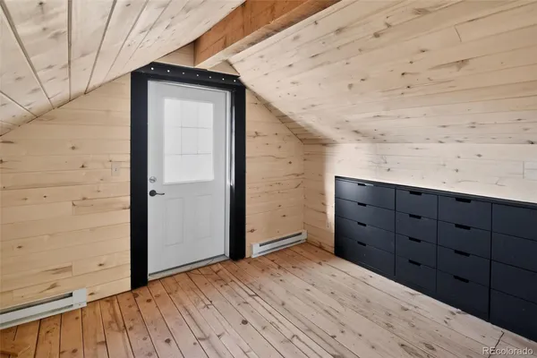 a view of a wooden door and an empty room