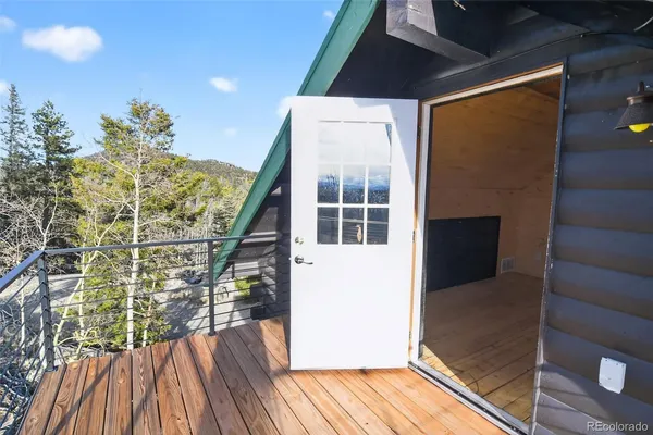 a view of balcony with wooden floor and fence