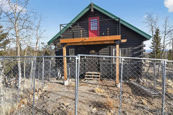 a front view of a house with wooden fence
