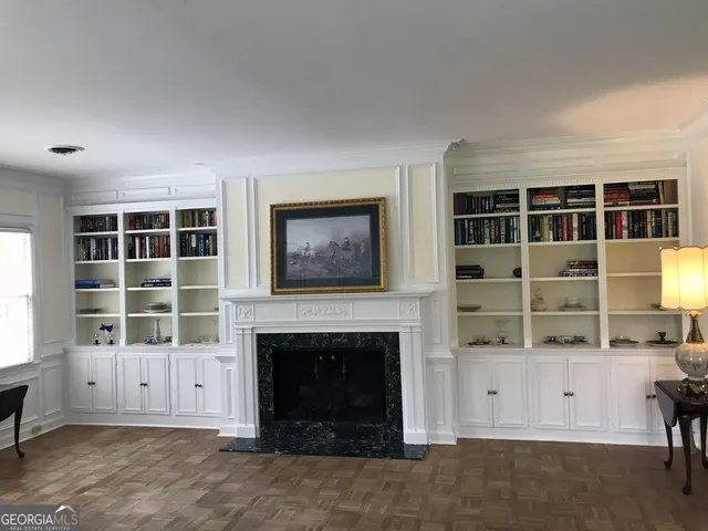 a view of a livingroom with wooden floor and a chandelier