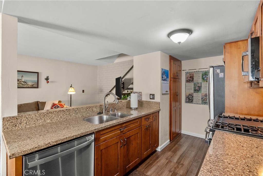 28152 Robin Avenue Saugus, CA 91350 - Photo 17 of 49 a kitchen with stainless steel appliances granite countertop a sink stove and cabinets